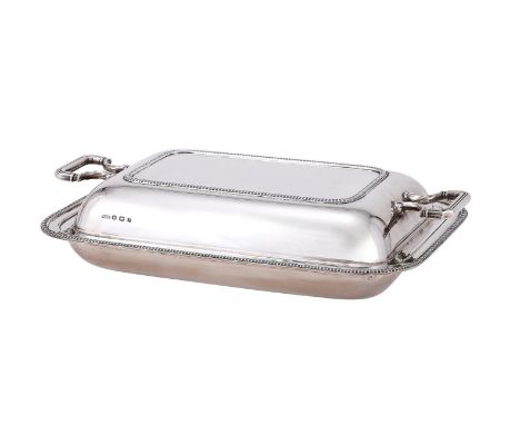 
	
		A SILVER ENTREE DISH AND COVER
		MAPLE &amp; CO., SHEFFIELD 1932
		With twin reeded loop handles and gadrooned borders
	
