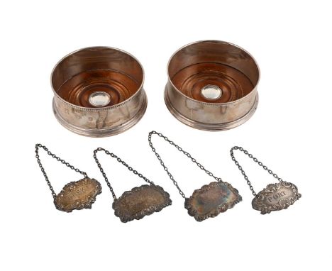 
	
		A PAIR OF SILVER MOUNTED BOTTLE COASTERS AND FOUR DECANTER LABELS 
		To include: a pair of silver mounted bottle coaster
