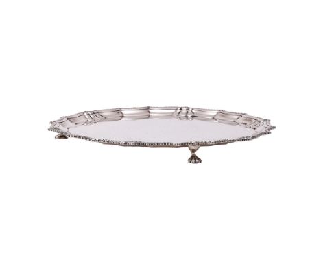 
	
		A SILVER SHAPED CIRCULAR SALVER
		BARKER BROTHERS SILVER LTD., BIRMINGHAM 1932
		With a gadrooned border and on three li