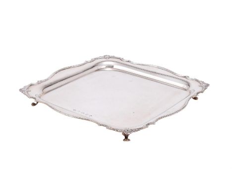 
	
		A SILVER SHAPED SQUARE SALVER
		ALEXANDER CLARK &amp; CO. LTD., BIRMINGHAM 1935
		The raised rim with shells and scrolls