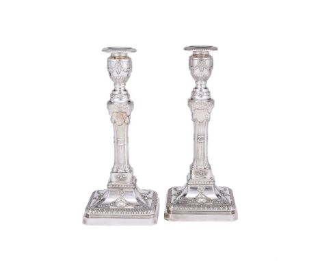 
	
		A PAIR OF SILVER CANDLESTICKS
		BARKER ELLIS SILVER CO., BIRMINGHAM 1992
		With foliate chased circular sconces, urn sha