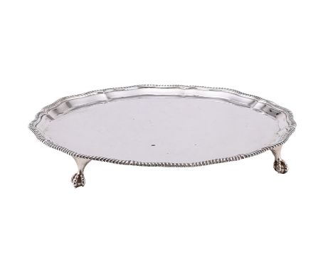 
	
		A SILVER SHAPED CIRCULAR SALVER
		GOLDSMITHS &amp; SILVERSMITHS CO. LTD., LONDON 1940
		With a gadrooned border and on f
