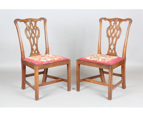 A pair of George III Chippendale period mahogany carved and pierced splat back dining chairs with drop-in needlework seats, h