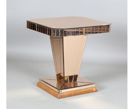 An Art Deco peach tinted mirror occasional table, the canted square top on a tapering column, height 62cm, width 60cm.Buyer’s