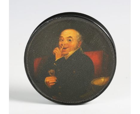 An early 19th century papier-mâché circular snuff box, the lid painted by Samuel Raven with a portrait of a gentleman holding