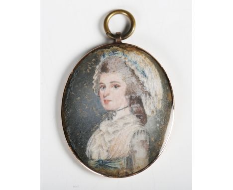 A mid-19th century watercolour portrait miniature of a lady wearing a bonnet, within a gold backed frame, 4.8cm x 4cm.Buyer’s