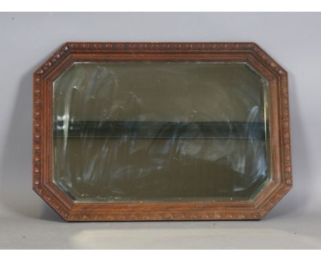 A George V oak canted rectangular wall mirror with a bevelled glass, 89cm x 63cm.Buyer’s Premium 29.4% (including VAT @ 20%) 