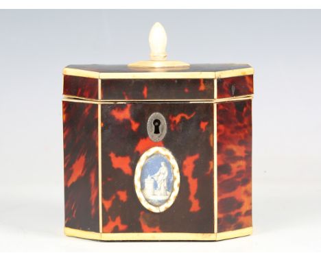 A George III red stained tortoiseshell and ivory mounted canted rectangular tea caddy, the front with a glazed oval reserve p