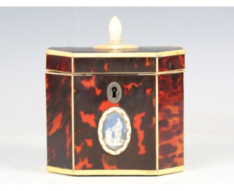 A George III red stained tortoiseshell and ivory mounted canted rectangular tea caddy, the front with a glazed oval reserve p