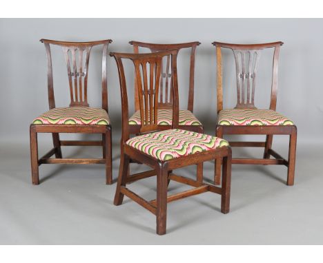 A set of four George III Chippendale period mahogany pierced splat back dining chairs, the drop-in seats covered in polychrom