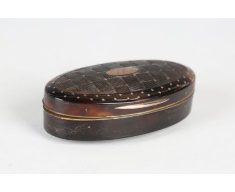 A late George III tortoiseshell oval snuff box, the hinged lid with piqué inlaid gold stars and dots, carved to imitate a wov