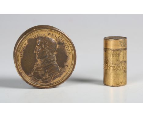 A 19th century gilt metal commemorative cylindrical box and cover, the cover cast with a portrait of the 'Duke of Wellington'