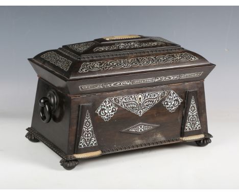 An early Victorian coromandel and mother-of-pearl inlaid tea caddy of sarcophagus form, the interior fitted with two removabl