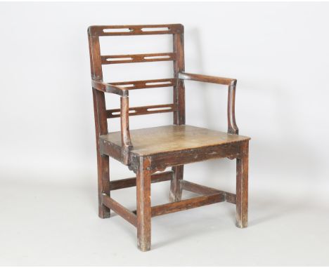 A George III provincial oak pierced ladder back elbow chair with solid seat, height 92cm, width 64cm.Buyer’s Premium 29.4% (i