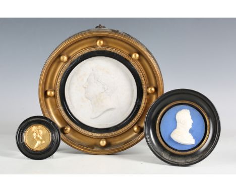 A late 19th century blue dip jasperware portrait plaque, diameter 8.5cm, mounted within an ebonized frame, a plaster plaque d
