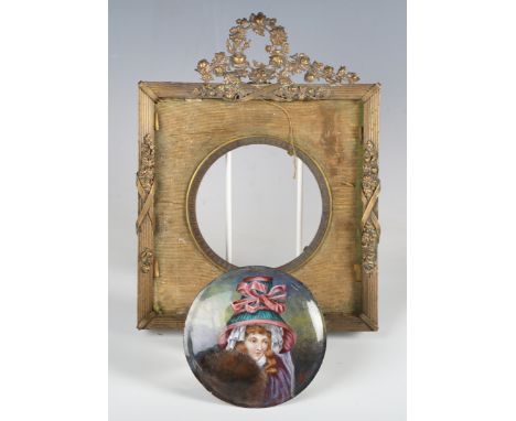 A late 19th century enamelled copper tondo portrait miniature depicting a young girl wearing a large hat, indistinctly signed