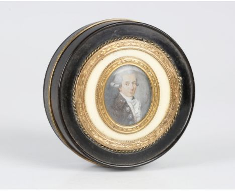 A George III tortoiseshell and gilt metal mounted circular snuff box and cover, the ivory mounted lid inset with a glazed ova