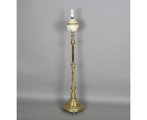 A late Victorian brass telescopic lamp standard fitted with a Royal Worcester reservoir, the spiral decorated stem on a heavy