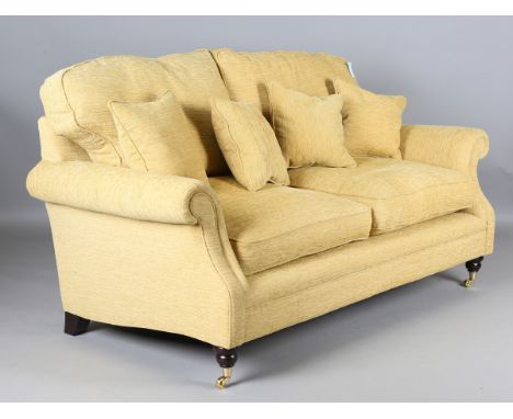 A Laura Ashley two-seat sofa, upholstered in yellow fabric, height 80cm, width 183cm, depth 95cm.Buyer’s Premium 29.4% (inclu