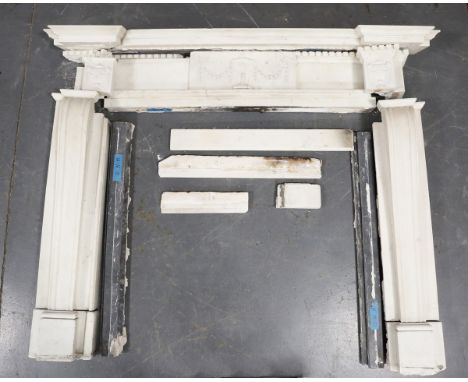 A George III style white marble fireplace, 20th century and earlier elements, the inverted breakfront mantel above dentil mou