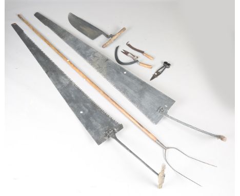 A 19th century pitchfork with long wooden handle, length 286cm, a similar vegetable fork, two 19th century pit saws, another 