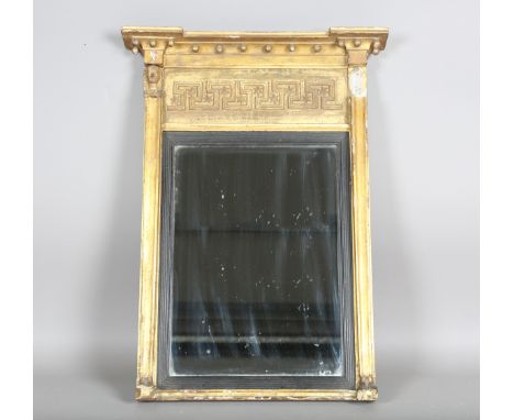 A Regency Egyptianesque giltwood and gesso pier mirror, the ballshot pediment above a running scroll and star frieze flanked 