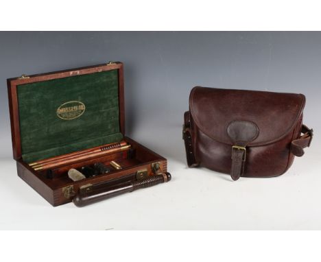 A brown leather gun cartridge bag, width 28cm, a modern gun cleaning kit by Parker-Hale and a small wooden truncheon.Buyer’s 