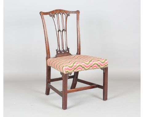 A George III Chippendale period mahogany dining chair, the finely carved Gothic tracery back above an overstuffed seat, heigh