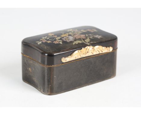A mid-19th century tortoiseshell and gilt metal mounted shaped rectangular snuff box, the hinged lid inlaid with a floral spr