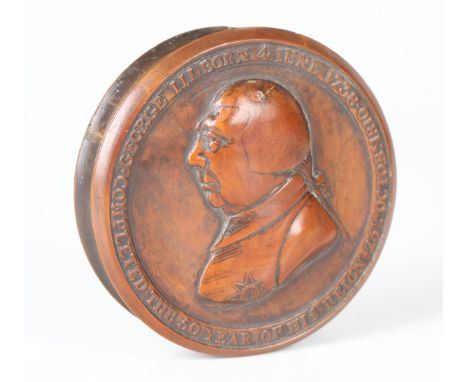 A George III commemorative boxwood circular snuff box, the removable lid decorated in relief with a profile portrait of the K