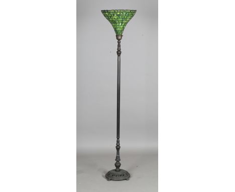 A modern Tiffany style standard lamp with green glass uplighter shade above a fluted metal column and circular foliate pierce
