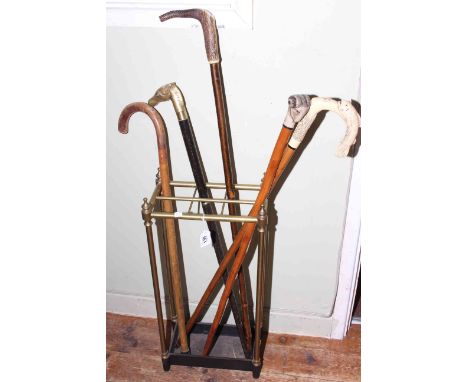 Brass six compartment stick stand and walking sticks including bone handled, stand measures 65cm high.