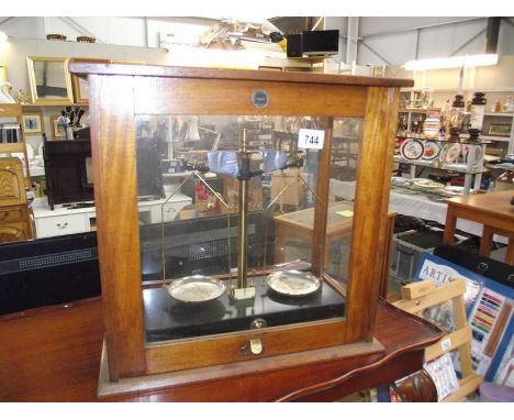 A cased set of chemist's scales.