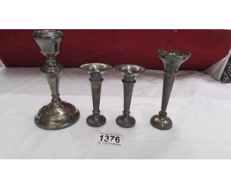 A pair of small hall marked silver spills, a single silver spill and a single silver candlestick.