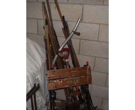 A good lot of garden tools and a work bench.