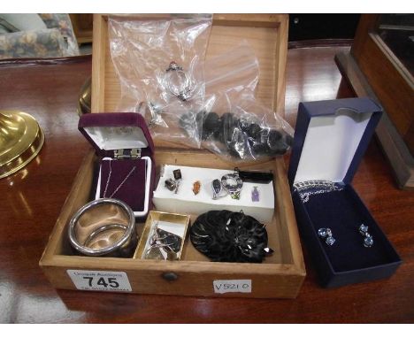 A wooden box of vintage and contemporary jewellery including rings, sets of earrings, engraved napkin ring etc.,