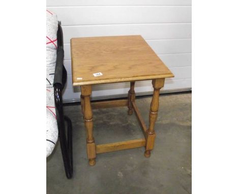 A polished light oak side table.