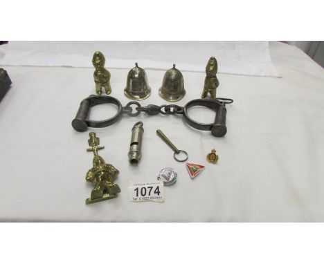 A mixed lot of police related items including hand cuffs, police helmet bells, door knocker, whistle etc.,