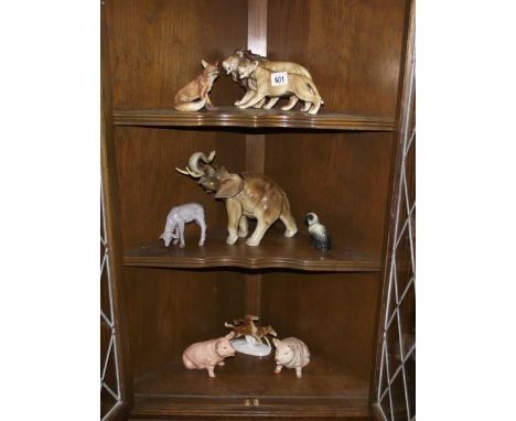 8 ceramic animal figurines including lions, elephant etc.