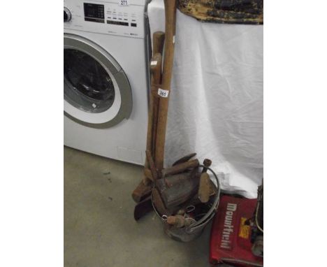 2 axes, a sledge hammer and a bucket of tools.