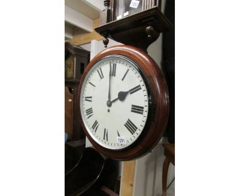 A circular mahogany wall clock.