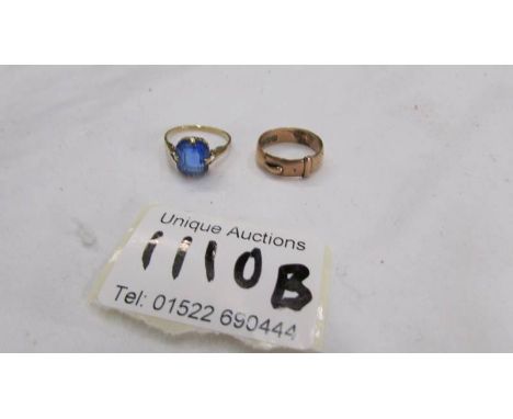 A 9ct gold ring set blue stone, size L and a 9ct gold buckle ring, size J.