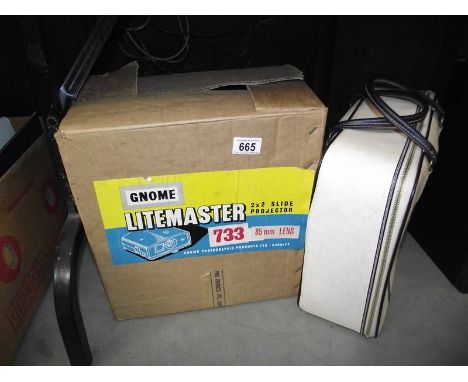 A boxed Gnome Litemaster 733 slide projector