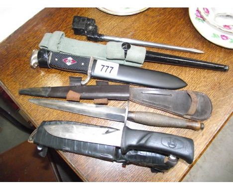 A vintage military dagger, a 303 bayonet, a replica German dagger and a knife.