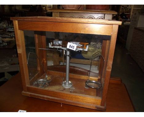 A cased set of chemist's scales (glass loose to top of case), collect only.