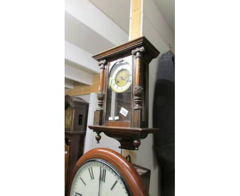 A small mahogany wall clock.