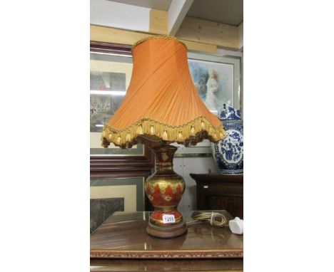 An oriental style table lamp with shade.