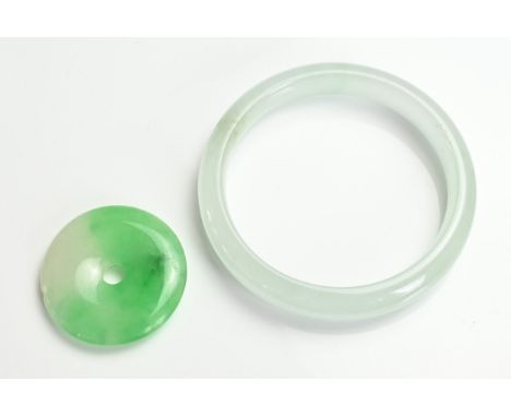 A CHINESE JADE JADEITE BANGLE AND BI DISC PENDANT. The bangle pale greenish white, 7.2cm outer diameter and 6cm inner diamete