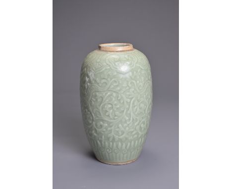 A CHINESE PALE CELADON PORCELAIN JAR, 19TH CENTURY. Of ovoid form with moulded decoration of two opposing dragons on a leafy 