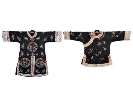TWO 20TH CENTURY CHINESE EMBROIDERED SILK BLACK-GROUND WOMAN'S ROBES. The first of tunic form, in silk and rayon, embroidered